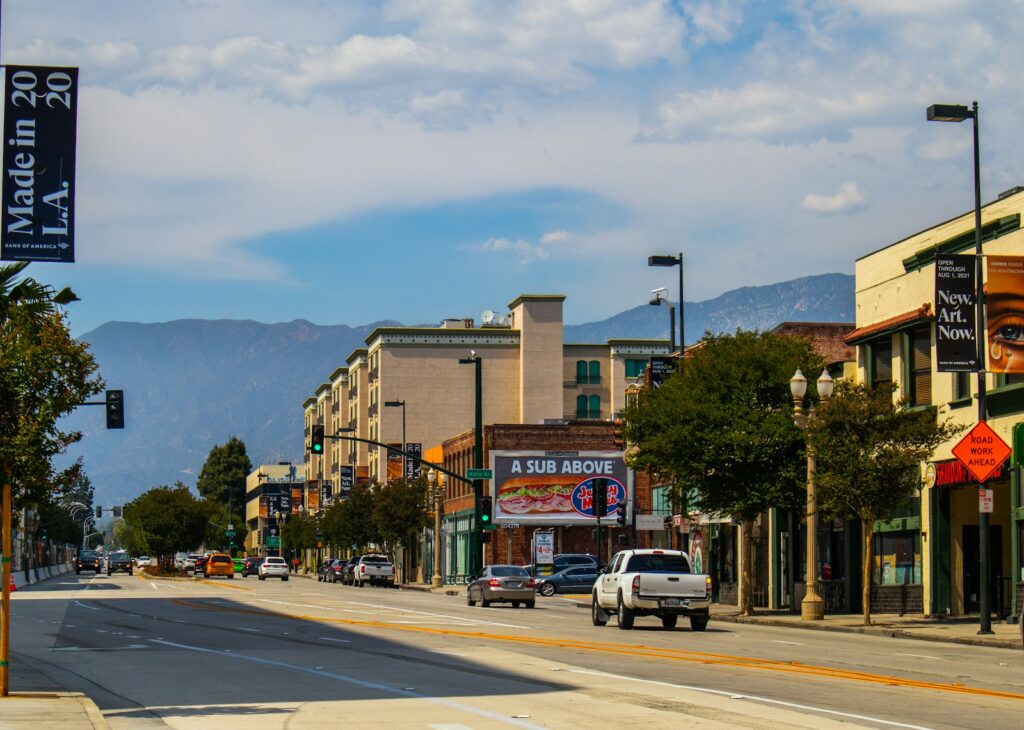 a city street with cars parked on the side of the road